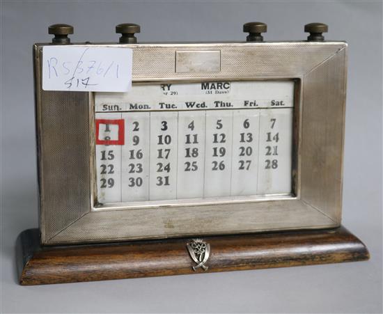 An engine turned silver mounted desk calendar with Gurkha crest.